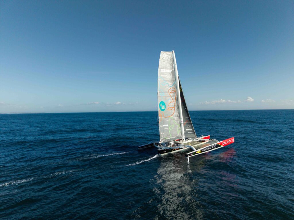 Le maxi-trimaran IDEC SPORT-CIC sous voiles au large, vue aérienne